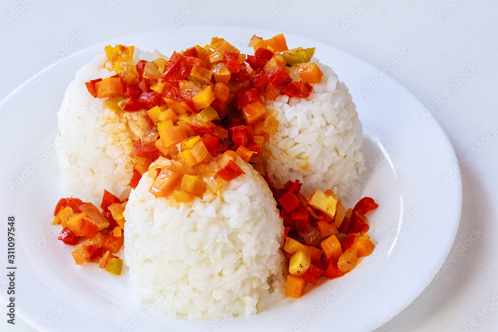A plate of rice with vegetables. White background. A plate of rice with vegetables. White background.