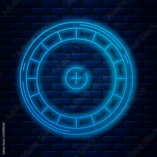 Glowing neon line Casino roulette wheel icon isolated on brick wall background. Vector Illustration