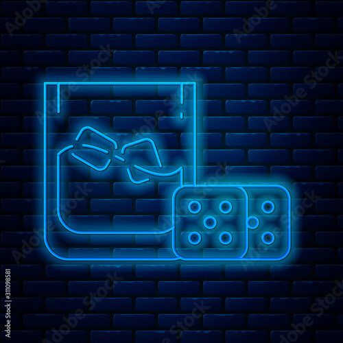 Glowing neon line Game dice and glass of whiskey with ice cubes icon isolated on brick wall background. Casino gambling. Vector Illustration