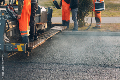 Asphalt paving. Paver machine and workers. New road construction. photo