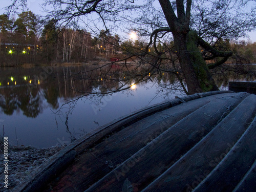 Canvas Print boat reflection of trees in water at sunset, sweden, sverige, nacka, stockholm
