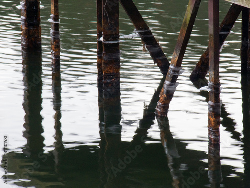 reflection of poles in water, stockholm,nacka,sweden,sverige © Mats