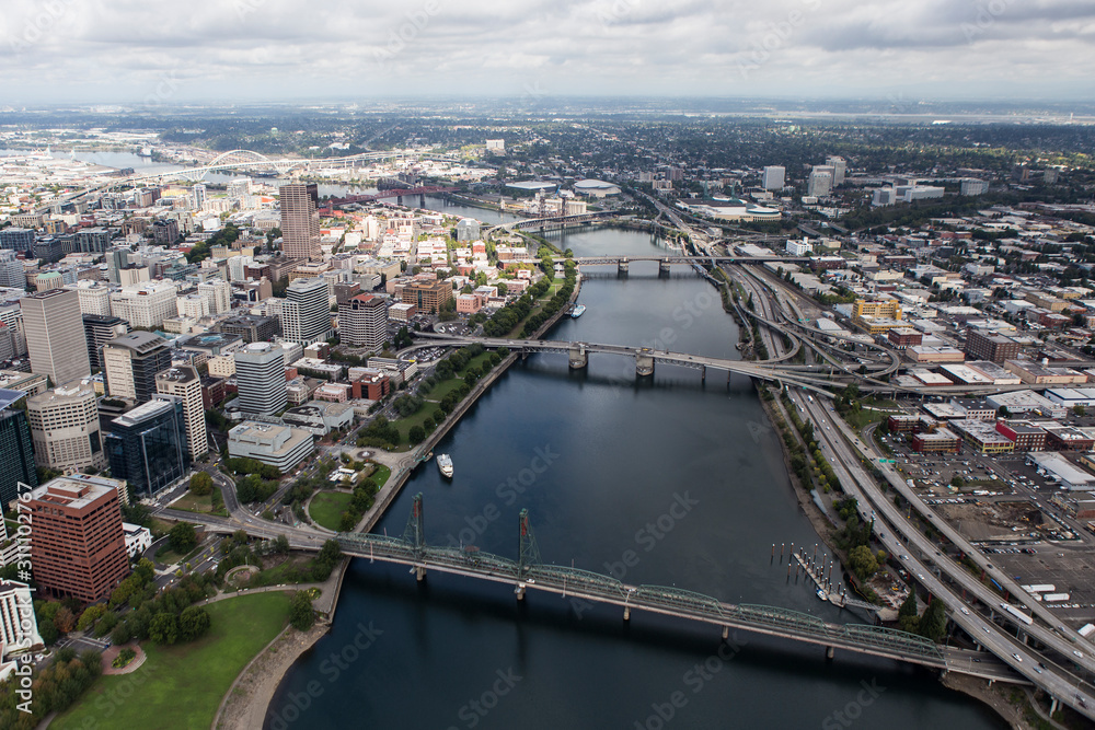 Aerial view of the Williamette River, bridges, buildings and streets in downtown Portland, Oregon, USA.