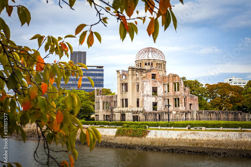 Hiroshima, Japan - October 2 2019: The ruins of the Hiroshima atomic bomb dome on an Autumn evening. Now listed as a World Heritage site to communicate the devastation caused by nuclear weapons. photo