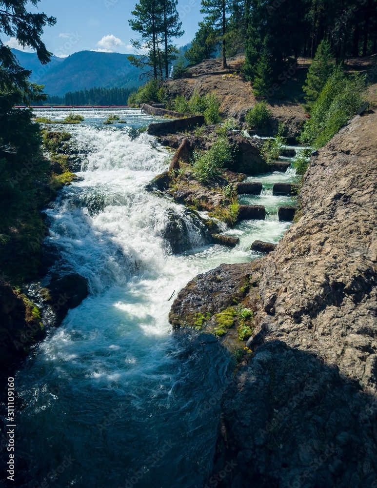 Cascading Clear Lake Falls with Fish Ladder surrounded by rocky cliffs
