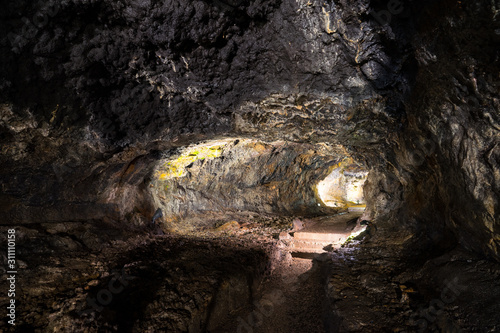 Illuminated lava tunnels in Sao Vicente Caves and Volcano Center. Result of the ancient volcanic eruption and magma flow now presented to tourists.