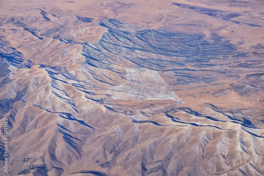 Fototapeta premium Colorado Rocky Mountains Aerial view from airplane of abstract Landscapes, peaks, canyons and rural cities in southwest Colorado and Utah. United States of America. USA.