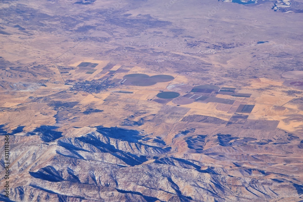 Fototapeta premium Colorado Rocky Mountains Aerial view from airplane of abstract Landscapes, peaks, canyons and rural cities in southwest Colorado and Utah. United States of America. USA.