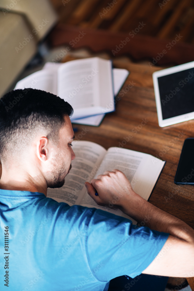 young man reading a book young man reading a book