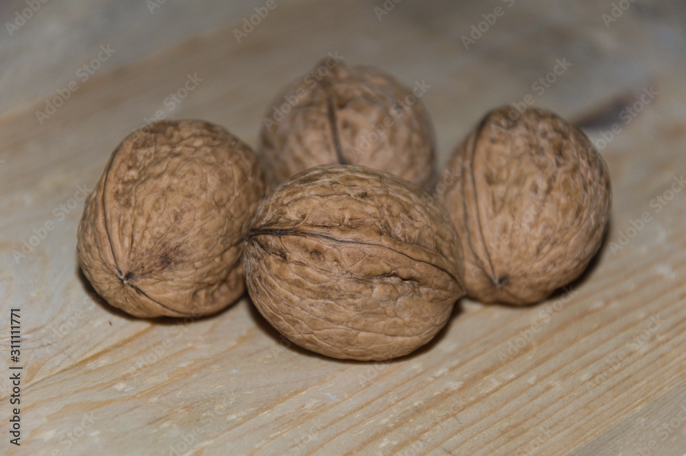 Whole walnuts on a vintage wooden background. Selective focus