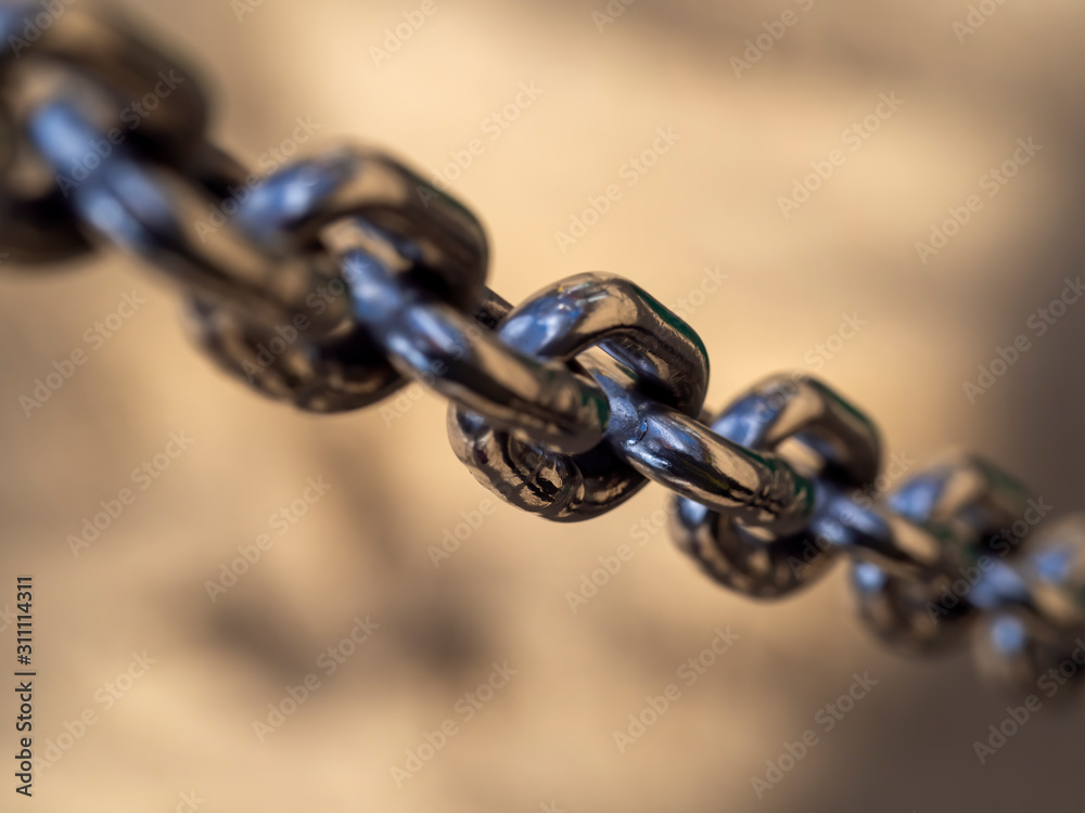 Fototapeta premium shiny chrome chain front of the blurry background