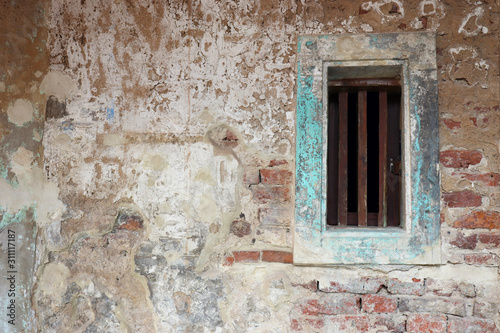 cement surface brick grey old wall with shabby damaged plaster background of an vintage dirty Textured wallpaper Fungus stains with window