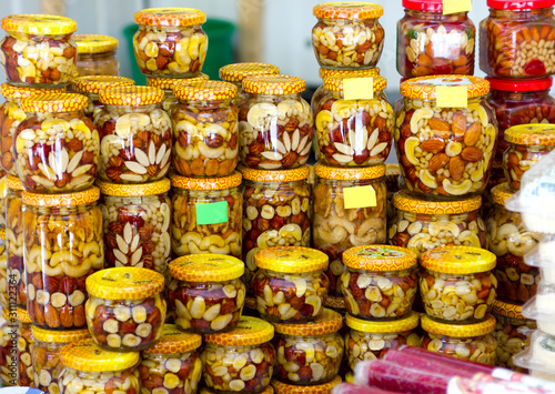 nuts filled with honey in glass jars souvenir in the oriental bazaar