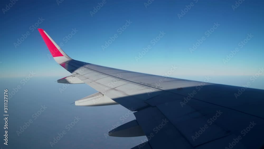 Aircraft wings are flying hovering with the sun rays of the sun are all over. 4K UHD Aircraft wings are flying hovering with the sun rays of the sun are all over. 4K UHD