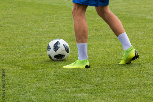 Soccer balls on the stadium lawn.