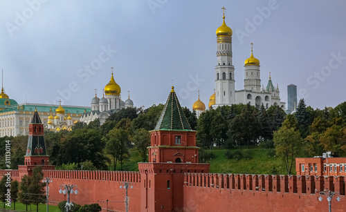The Kremlin wall, tower and domes of cathedrals blurred in a winter snow storm with snowflakes in the air, Moscow Russia