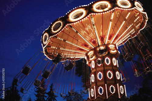Carousel Merry-go-round in amusement park at a night city