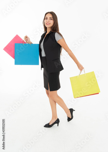 Women dressed in skirts and T-shirts and waistcoats Wear shoes Carrying a colorful bag She felt very happy to have a shopping. Shot on a white background © Siriroj