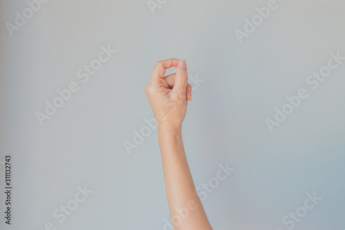 Caucasian female hand gesture or Hand in gesturing with gray background.