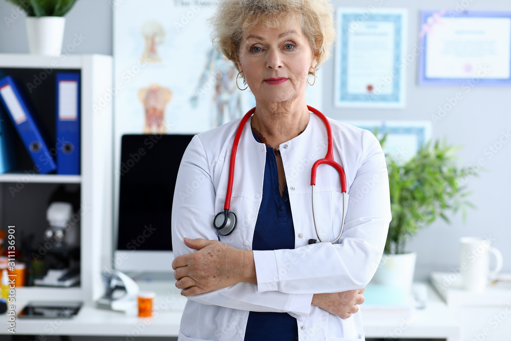 Female mature doctor against medical hospital Female mature doctor against medical hospital