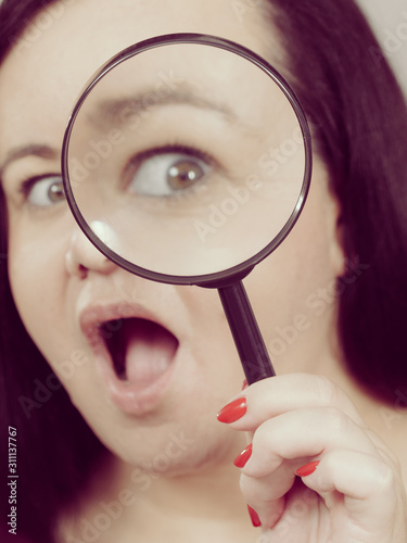 Adult woman with magnifying glss