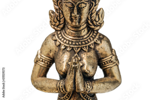 Eastern deity goddess fairy or angel praying with folded hands in front of his chest. bronze gold figurine close up, isolyate