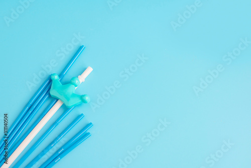 plastic straws on a blue background  copy space