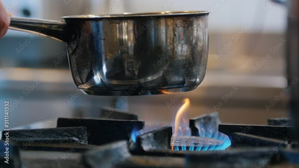 Boiling water in pot on the restaurant kitchen