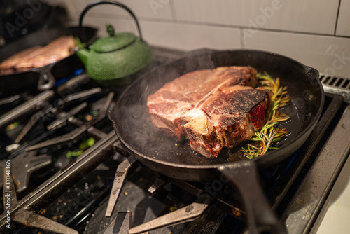 A reverse sear steak is cooked in a pan at home