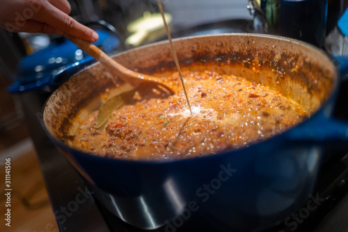 Homemade rigatoni pasta with bolognese being prepared