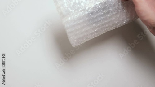  A man unpacks a parcel from China. Miniature models of figures for the board game Dungeons and Dragon. Close up. DnD Plastic gift toys.