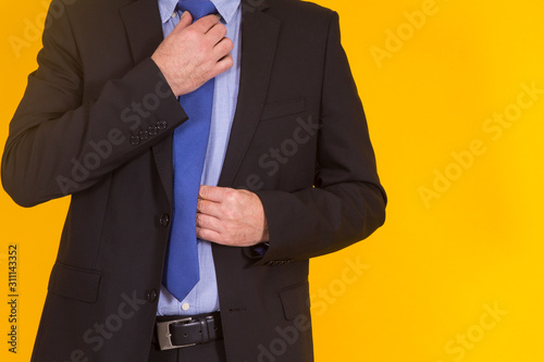 businessman placing his tie knot