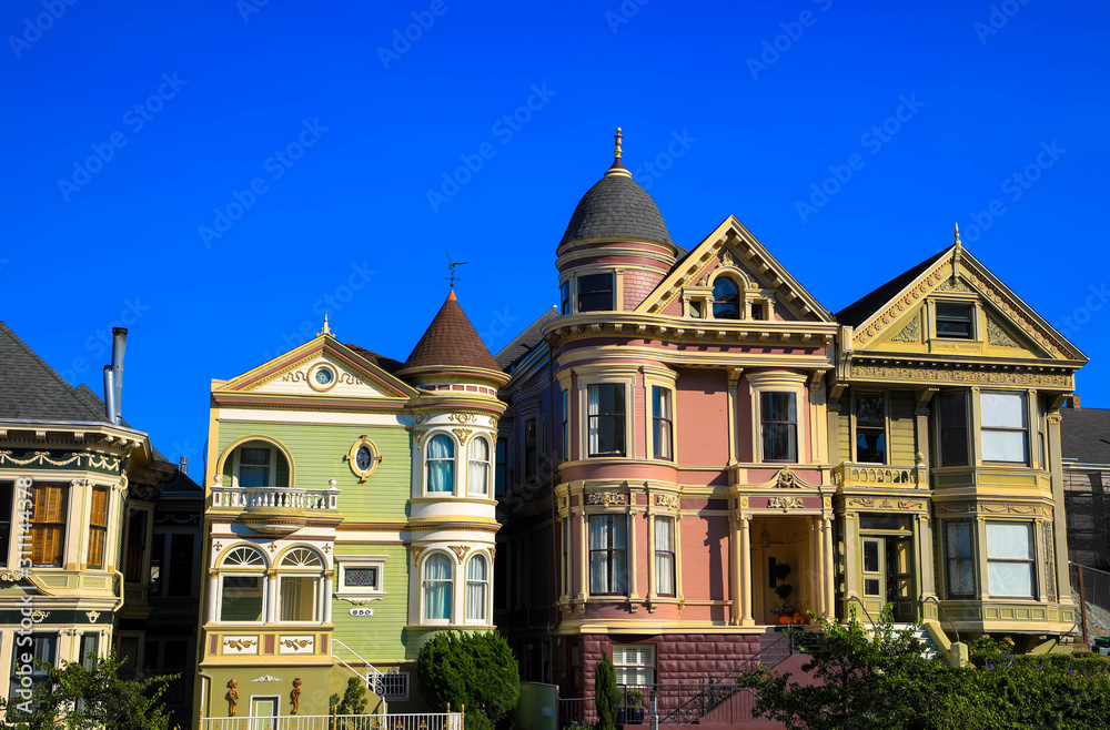 Beautiful view of Painted Ladies, colorful Victorian houses located near scenic Alamo Square in a row, San Francisco