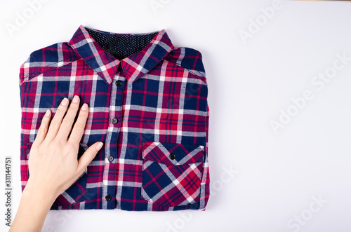 Textile, shirt composition on color background. Flat lay.