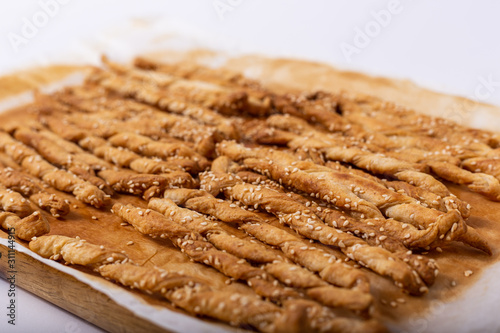 Homemade puff pastry sticks with sesame seeds