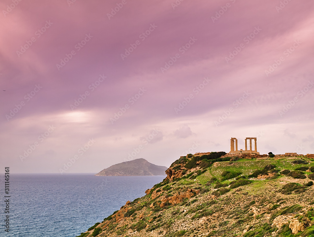 Sounio, Attica, Greece, ancient ruins of Poseidon temple under sky with clouds at winter time.