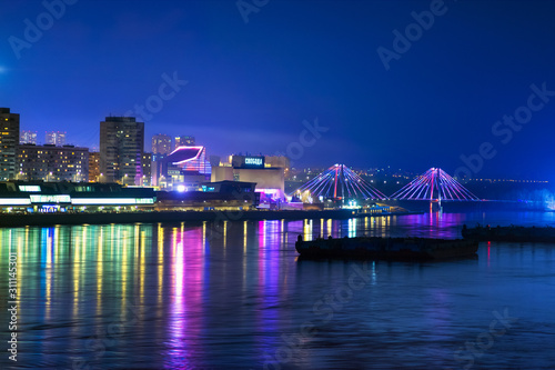 In the evening on the embankment of the Yenisei river in the Siberian city of Krasnoyarsk. Translation: 