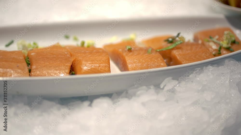 Slice of salmon filet on ice. Closeup of plate at munich food market. Blur background Slice of salmon filet on ice. Closeup of plate at munich food market. Blur background