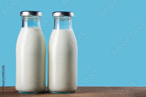 Bottle of milk on a blue background. Close-up. Healthy food.