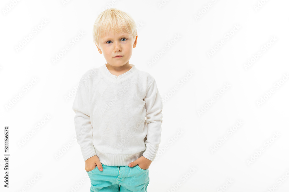 cute blond baby in a white t-shirt on a white background with copy space cute blond baby in a white t-shirt on a white background with copy space