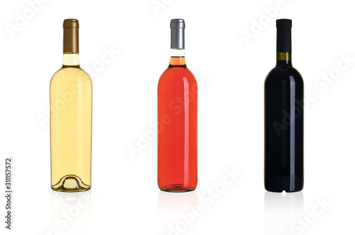 Three bottles of wine isolated on white background. White, pink and red wine in bottles.