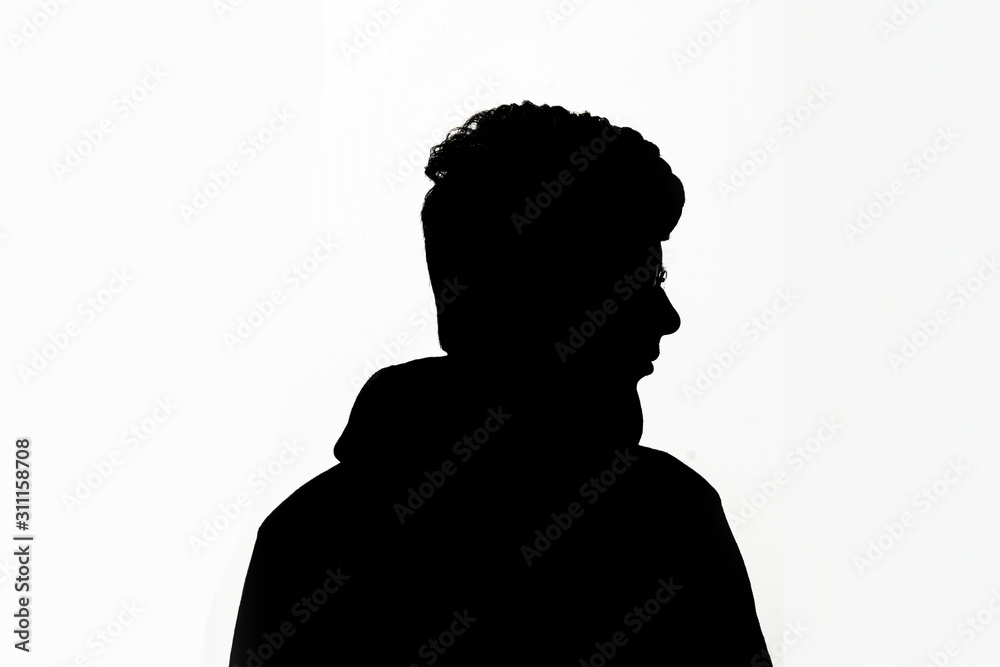 Silhouette of man from front on a white background looking sideways