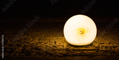 Old and dirty electric yellow lamp on a textured wall