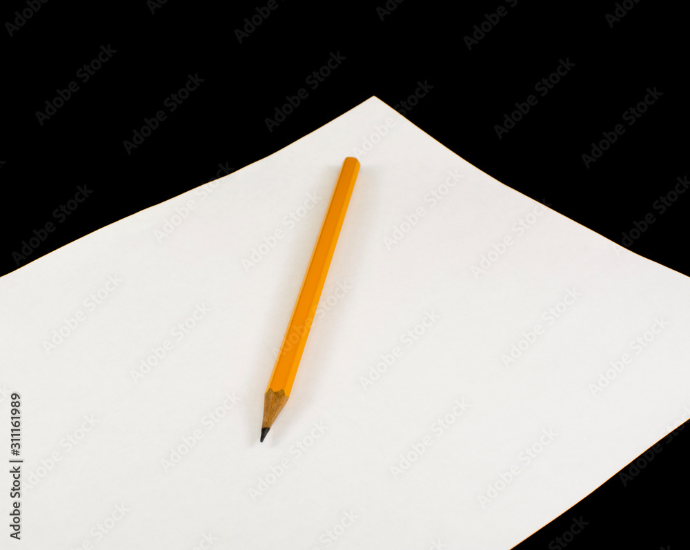 Pencil lies on a blank sheet of paper Pencil lies on a blank sheet of paper