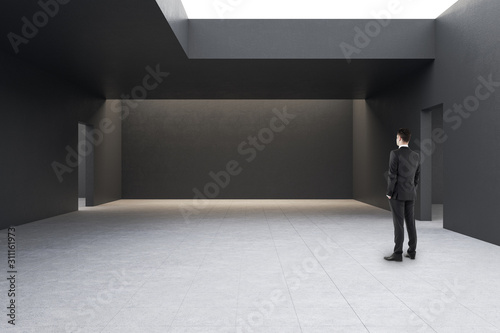 Businessman in modern gallery interior