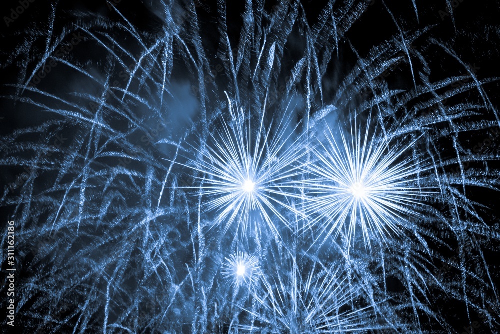 Obraz premium Luxury fireworks event sky show with blue big bang stars. Premium entertainment magic star firework at e.g. New Years Eve or Independence Day party celebration. Black dark night background
