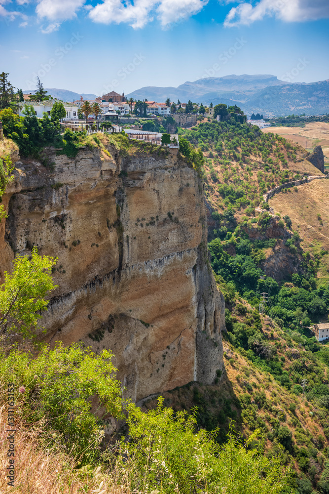 Ronda, Spain, a city in the Spanish province of Málaga, stand along a cliff on a sunny, summer day.