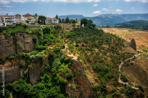 Ronda, Spain, a city in the Spanish province of Málaga, stand along a cliff on a sunny, summer day.