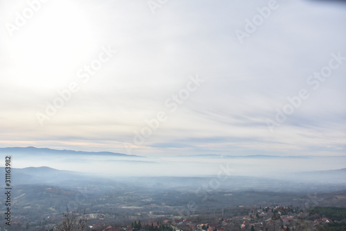 Environment pollution, foggy landscape of valley. Fog and pollution above the city of Nis, You can't see the city from smog
