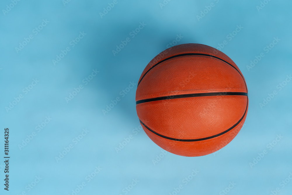 Ball for basket ball on an orange background